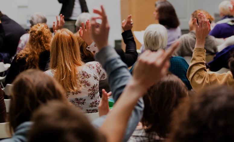 audience raising hands